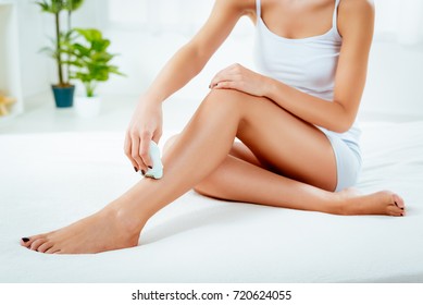 Close-up Of A Woman Depilation Her Leg With Electric Razor. 