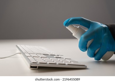 Close-up Of A Woman Disinfects A White Computer Keyboard. Slow Motion.