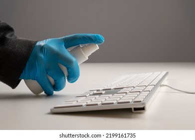 Close-up Of A Woman Disinfects A White Computer Keyboard. Slow Motion.