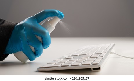 Close-up Of A Woman Disinfects A White Computer Keyboard. Slow Motion.