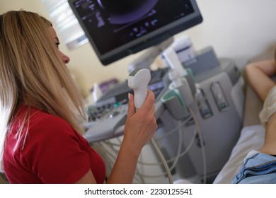 Close-up of woman doctor diagnostician specialist holding ultrasound probe. Physician preparing ultrasound machine for diagnosing of female patient - Shutterstock ID 2230125541