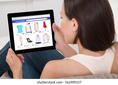 Close-up Of Woman Doing Online Shopping On Digital Tablet At Home