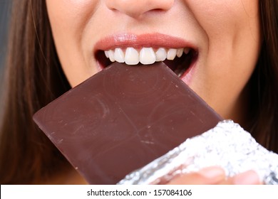 Closeup Of Woman Eating Chocolate 