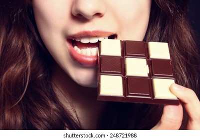 Closeup Of Woman Eating Chocolate