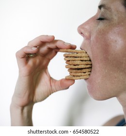 Closeup Woman Eating A Lot Of Cookies