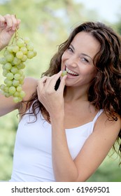 Closeup Of Woman Eating Grapes