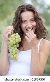 Closeup Of Woman Eating Grapes