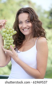 Closeup Of Woman Eating Grapes