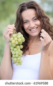 Closeup Of Woman Eating Grapes