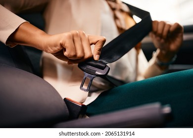 Close-up Of Woman Fastening Her Seatbelt In A Car.