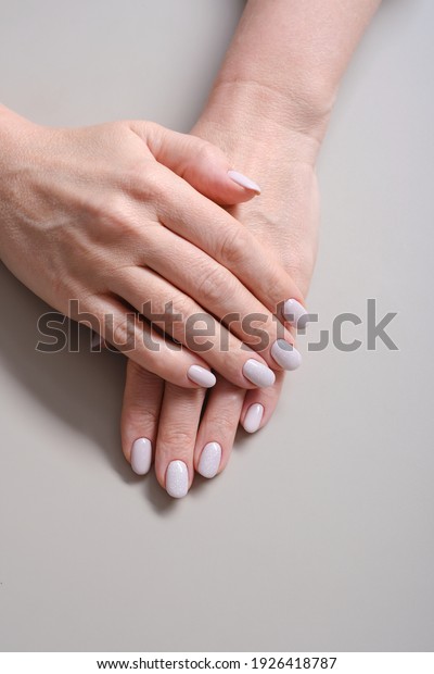 Close-Up Of Woman Fingers With Nail Art. Woman\
Hand With Pearl Nail\
Polish