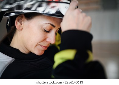 Close-up of woman floorball goalkeeper in helmet concetrating on game in gym. - Powered by Shutterstock