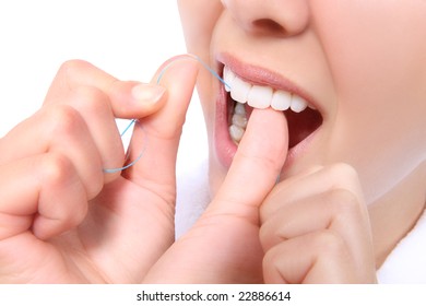 A Close-up Of A Woman Flossing Her Teeth