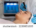 Close-up of woman getting facial hydro microdermabrasion peeling treatment. Female at cosmetic beauty spa clinic. Hydra vacuum cleaner. Cosmetology concept 