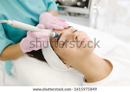 Close-up of woman getting facial hydro microdermabrasion peeling treatment. Female at cosmetic beauty spa slinic. Hydra vacuum cleaner. Cosmetology Stock fotó © 
