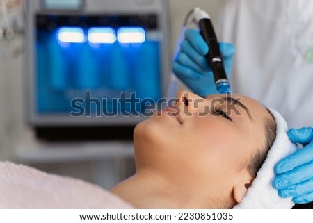 Close-up of woman getting facial hydro microdermabrasion peeling treatment. Female at cosmetic beauty spa clinic. Hydra vacuum cleaner. Cosmetology concept  Stock fotó © 