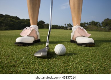 Closeup Of A Woman Golfer About To Make A Putt. Horizontal Shot.