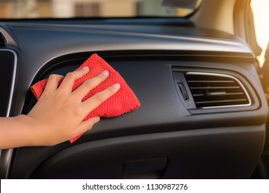 Closeup Woman Hand Is Cleaning Her Car Console With Microfiber Towel.