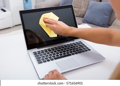 Close-up Of Woman Hand Cleaning Laptop Screen With Laptop At Home - Powered by Shutterstock