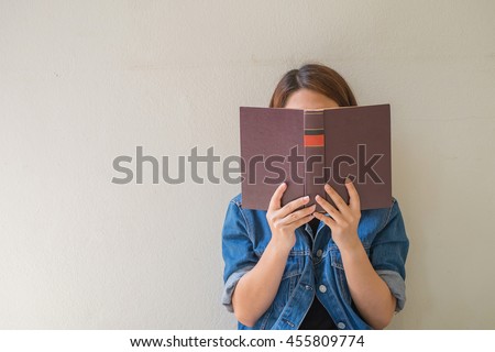 Closeup woman hand holding a book to read