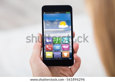 Close-up Of Woman Hand Holding Mobile Phone Showing Different Colorful Application