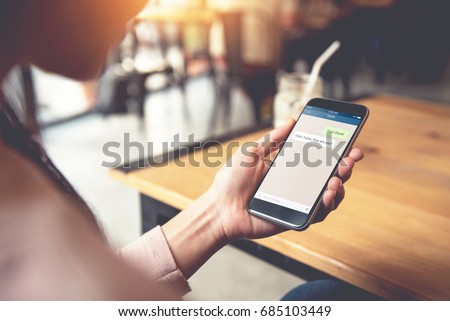 Closeup woman hand holding smart phone, Mock up to screen chat box. Social network, Chating and messaging concept, 