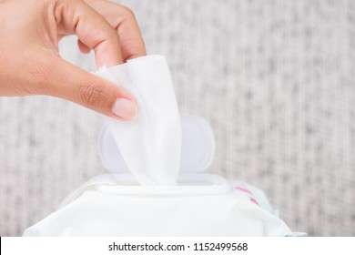 Closeup woman hand holding wet wipes from package. healthcare, people and medicine concept.
