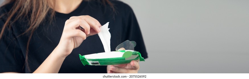 Closeup Woman Hand Holding Wet Wipes From Package.

