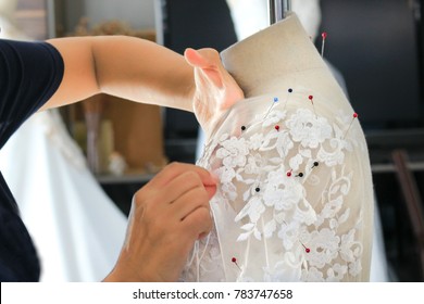 Closeup Of Woman Hand Sewing A Wedding Dress