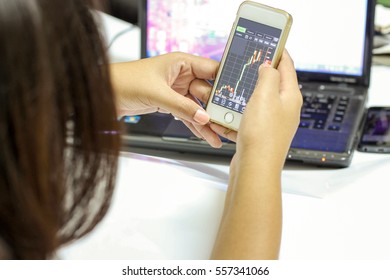 Closeup woman hand typing on smart phone,Business,stock trade - Shutterstock ID 557341066