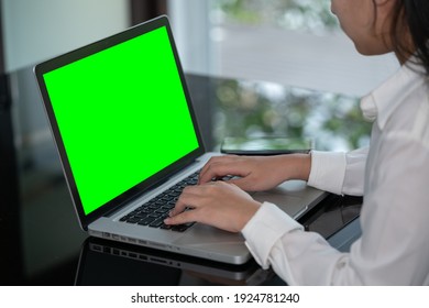 Closeup woman hand using computer laptop. Using online connect technology for business, education and communication. Green screen computer for graphic display montage. - Powered by Shutterstock