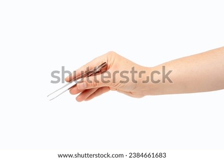 Close-up of woman hand using a small tweezers isolated on a white background