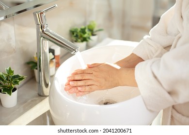 Close-up. Woman Hand Washing. Bright Bathroom, Modern Interior. Dressing Gown. Home Hygiene.