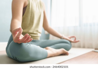 Closeup woman hand yoga lotus position at home. Breathing, Working out, Meditation, wellness concept - Powered by Shutterstock