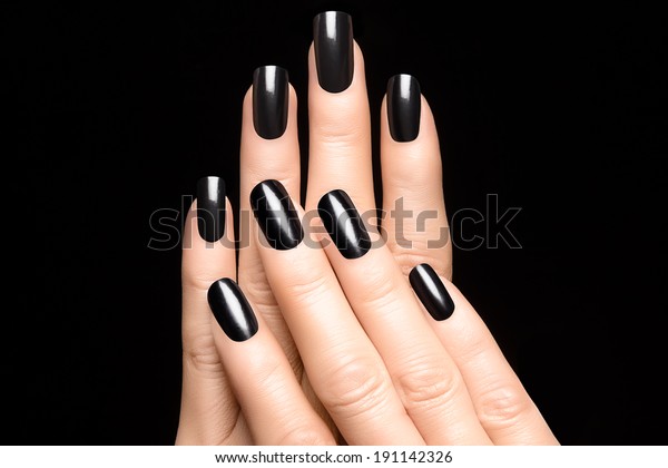 Closeup of\
woman hands with black nails.\
Manicure