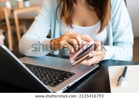 Closeup of woman hands cleaning her mobile phone Disinfect surfaces, high touch and daily use item to prevent the coronavirus disease pandemic, hygiene concept.