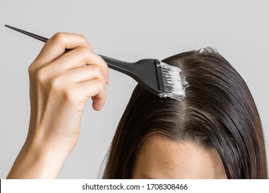 Closeup Woman Hands Dyeing Hair Using A Black Brush. Colouring Of White Hair At Home.