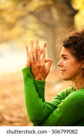 Closeup Of Woman Hands And Face In Yoga Position Outdoor In Autumn Park