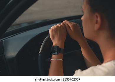 Close-up woman hands on the steering wheel, thoughtful driver. Smart watch on drivers hand. Angle view. - Powered by Shutterstock