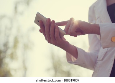 Closeup of woman hands using smartphone