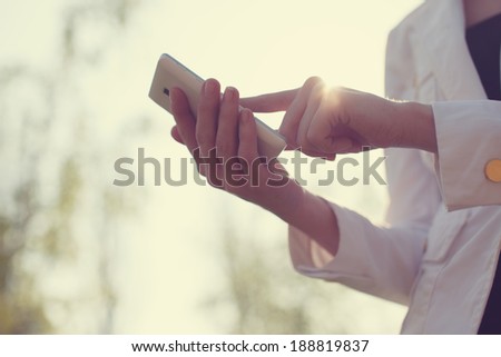 Closeup of woman hands using smartphone
