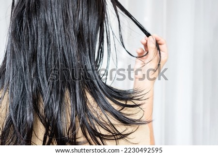 closeup woman have problems with oily hair and thinning hair 