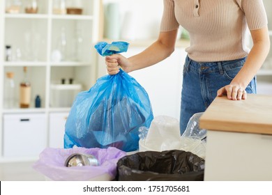 Close-up Of Woman Holding Big Bag With Garbage In Her Hands And Throwing It Into The Trash Bin