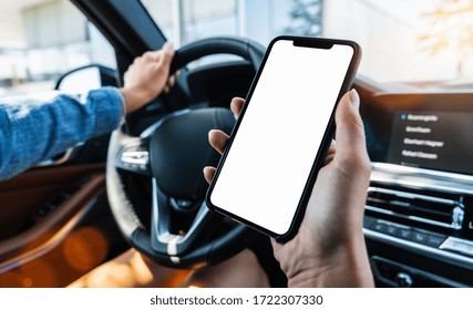 Close-up Of Woman Holding Black Mobile Phone In Hands With Blank Desktop Screen While Car Driving At Summer In The City, Mockup Image