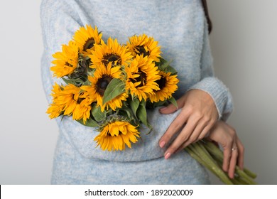 Closeup Of A Woman Holding A Hand Cut Bouquet Of Sunflowers