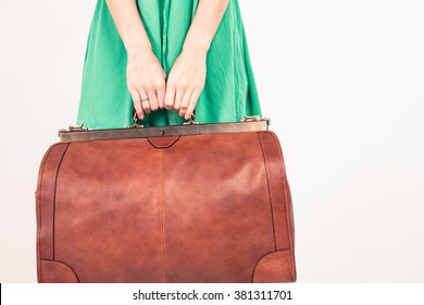 Closeup Woman Holding Hand Luggage At White Background. Vacation Rentals, Packages. Airport Terminal. Leather Suitcase Sale. Tourism. Vintage Tourist Bag. Weight, Baggage Dimensions. Baggage Allowance