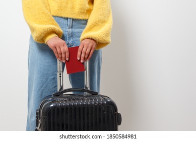 Close-up woman holding a passport and travel bag in her hands. Travel, immigration, emigration concept - Shutterstock ID 1850584981
