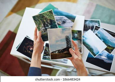 Close-up Of Woman Holding Photos In Her Hands Remembering Her Best Moments