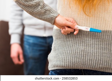 Close-up Of A Woman Holding Positive Pregnancy Test, Waiting To Surprise Her Lover.