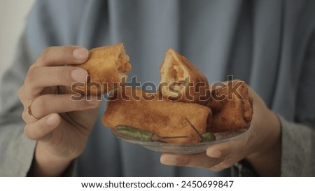 Closeup of woman holding Rissoles, Served on small Plate , Indonesian Traditional Snack